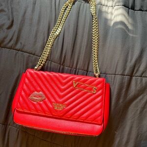 Victoria’s Secret red and gold purse